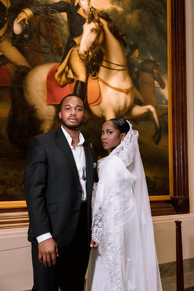 A bride and groom before a grand equestrian painting at the National Gallery of Art in Washington, DC